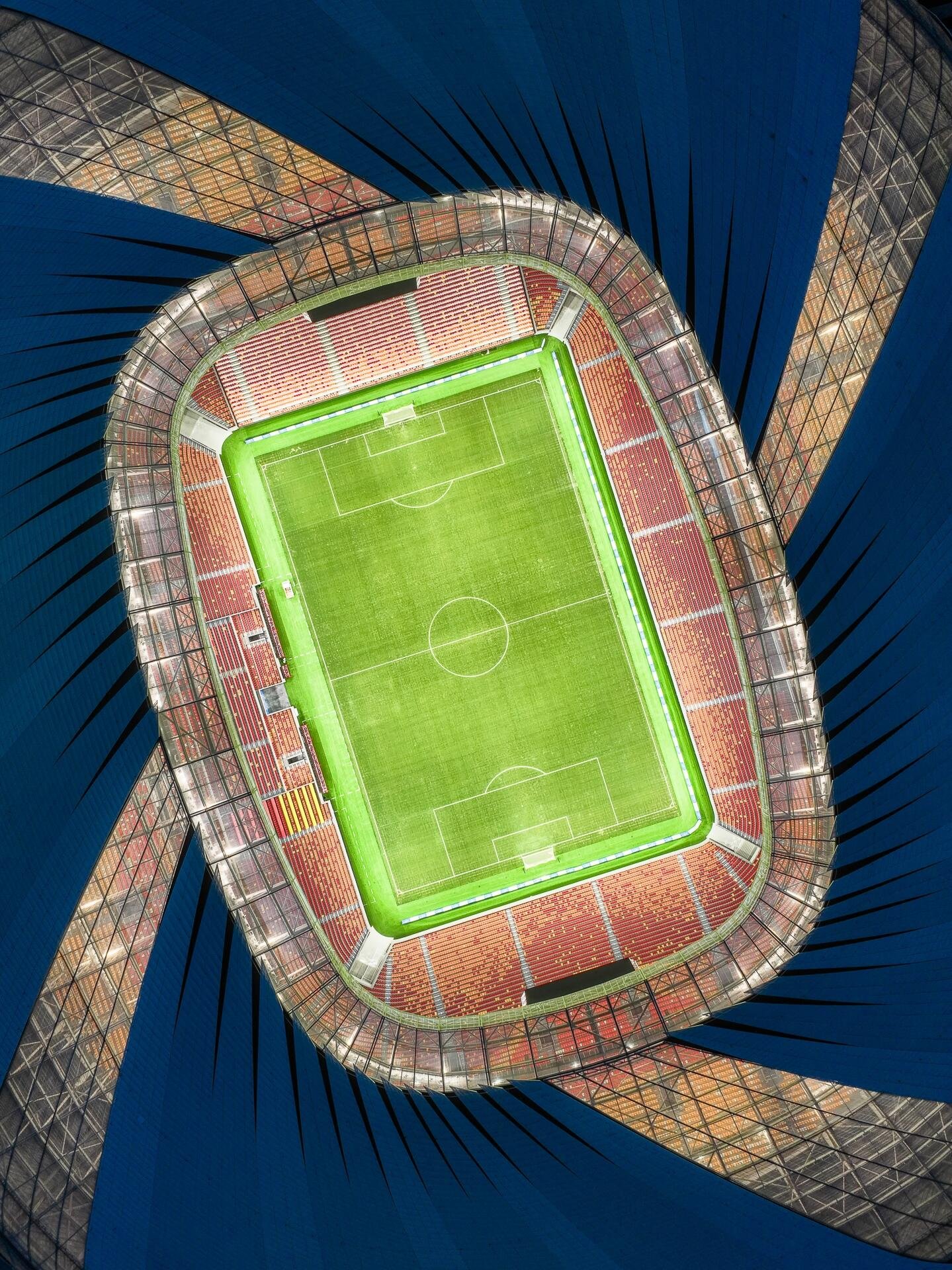 Spectacular night view of Chongqing Longxing Stadium, where dynamic LED lighting is diffused by the ETFE tensile structure, transforming the arena into a glowing landmark within the city skyline.