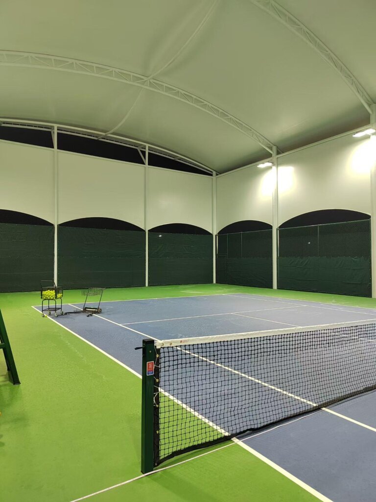 Modern tensile membrane architecture for a professional vocational school sports landmark.
