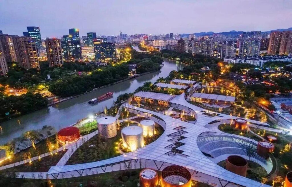 Illuminated commercial landmark ETFE canopy roof reflecting historic Grand Canal landscape